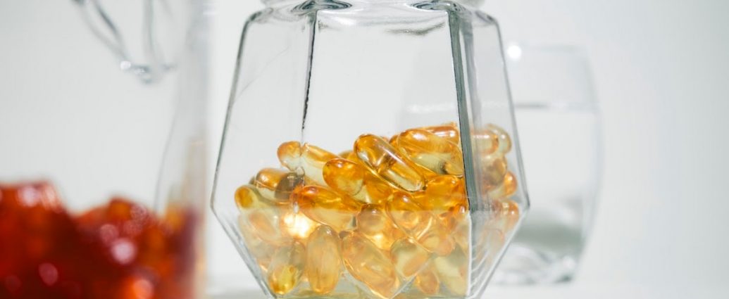 A glass jar filled with jelly beans next to another glass jar filled with jelly beans