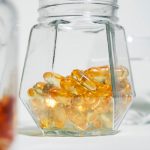 A glass jar filled with jelly beans next to another glass jar filled with jelly beans