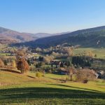 a scenic view of a valley in the mountains